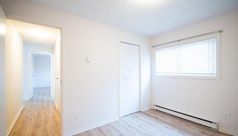 A room with a window and a door.