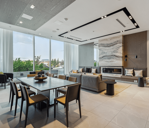 A modern dining room with a large table and chairs.
