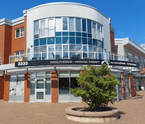 A building with a sign that reads "3333 Mossotherapy Massage Therapy".
