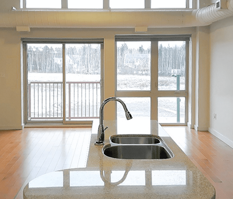 A kitchen sink with a faucet and a countertop.