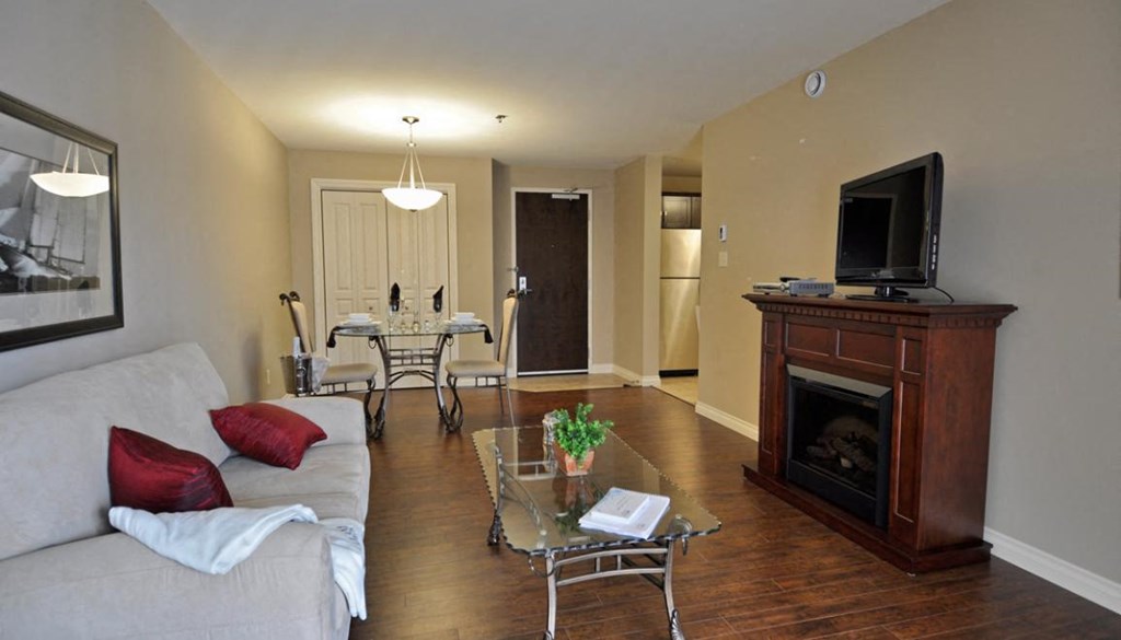 a living room with a couch and a table and a fireplace