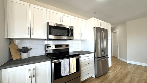 a kitchen with stainless steel appliances and white cabinets