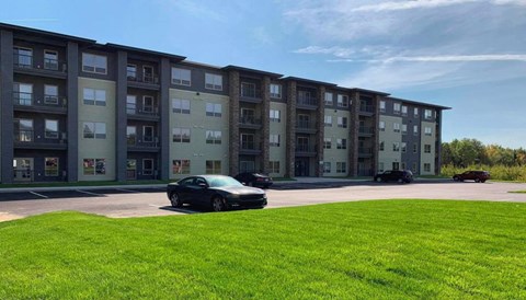 a car is parked in front of an apartment building