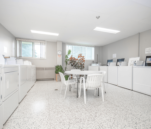 A white kitchen with a table and chairs.