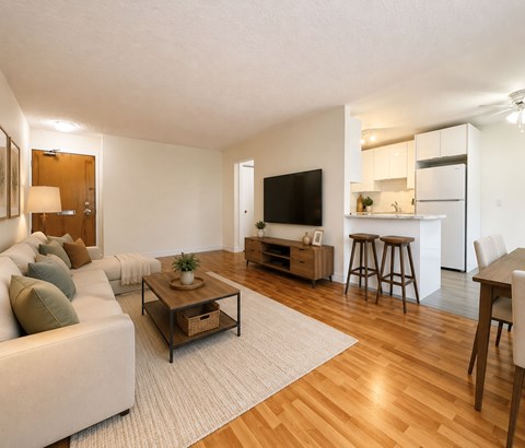 A living room with a white couch and a wooden coffee table.