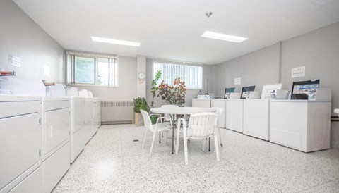 A white room with a table and chairs.