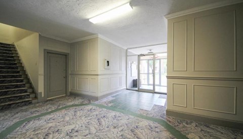 A room with a staircase and a door.