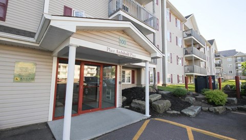 The entrance to a building with a sign that reads "100 Place Archibald Place".