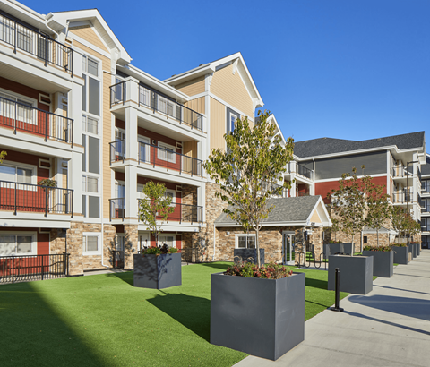 Apartment complex with a green lawn in front.