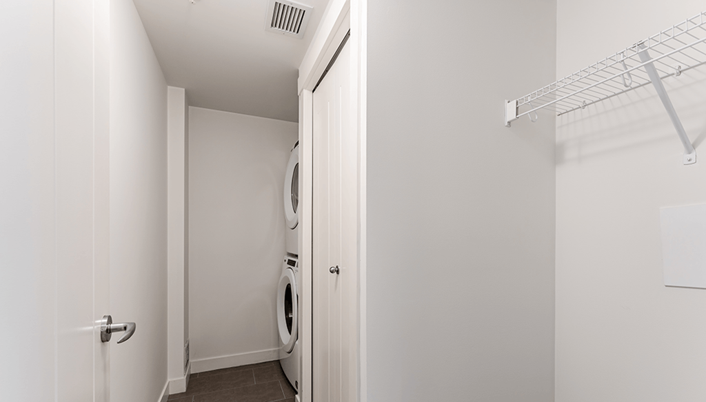 A white laundry room with a washer and dryer.