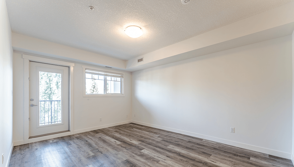 A room with a sliding glass door and a window.