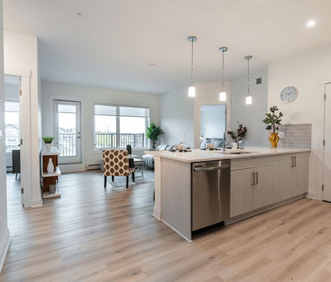 A modern kitchen with a dining table and chairs.