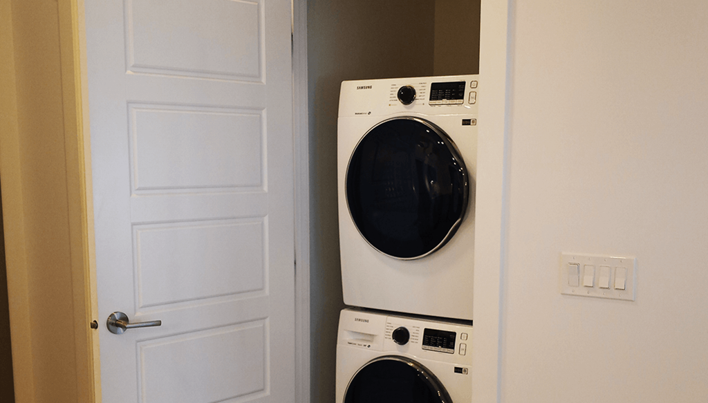 a front loading washer and dryer in a laundry room