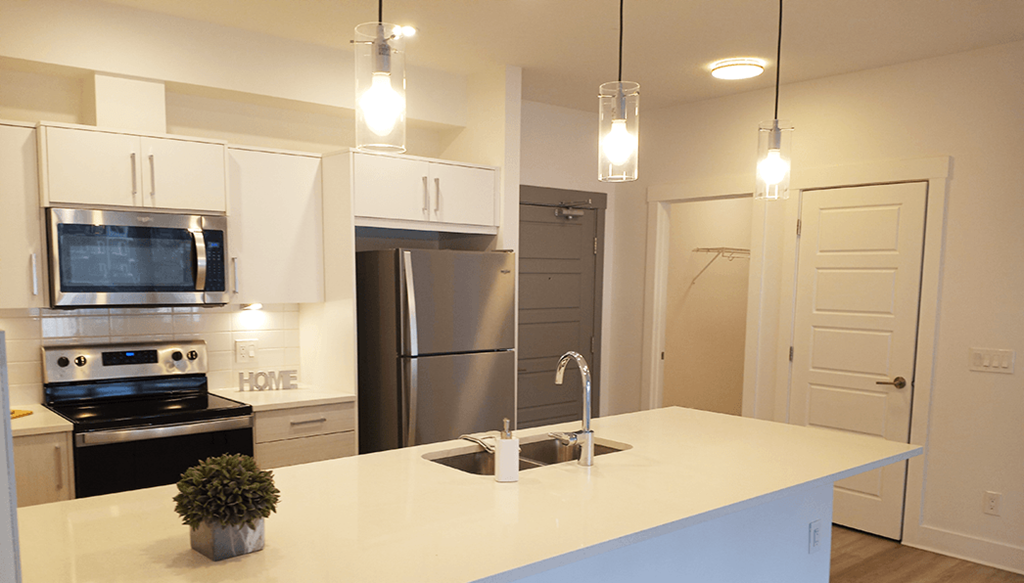 a kitchen with stainless steel appliances and a white counter top