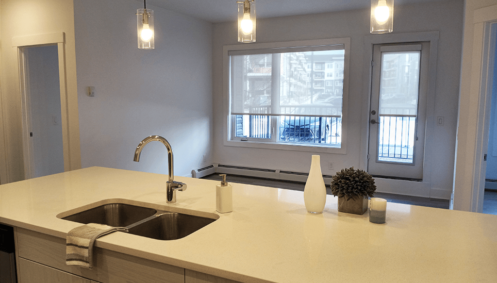 an empty kitchen with a sink and a window