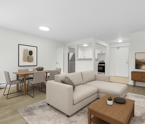 A modern living room with a beige sofa, a wooden coffee table, and a dining table with chairs.