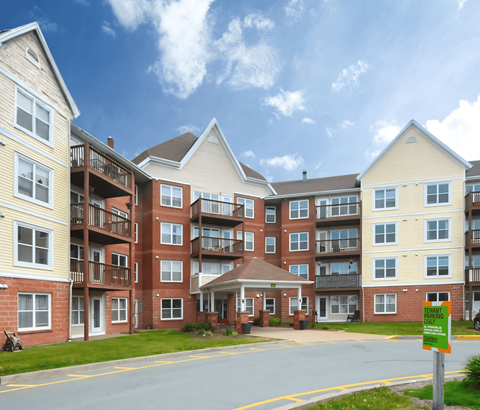 Apartment complex with a sign that says "Furnished Apartments Available".