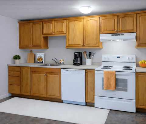 A kitchen with wooden cabinets and white appliances.