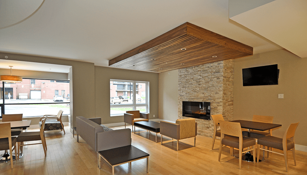 The Plaza Social Room With Fireplace & Tables