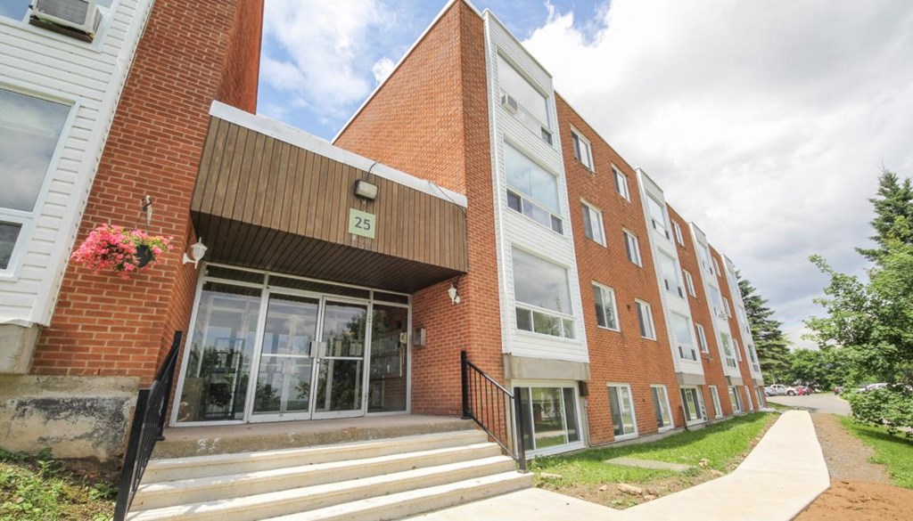 the front of a brick building with steps