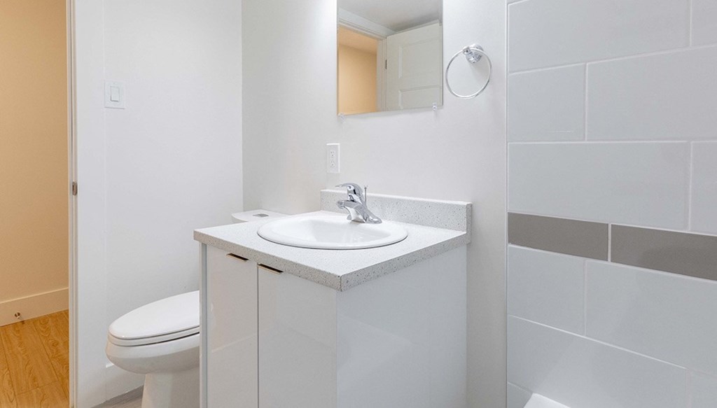 an empty bathroom with a sink and a toilet