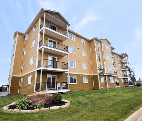A large apartment building with a balcony on the second floor.