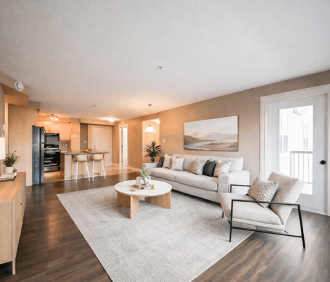A modern living room with a white sofa and a coffee table.