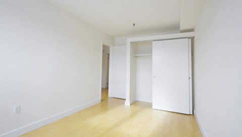 an empty room with white walls and sliding doors