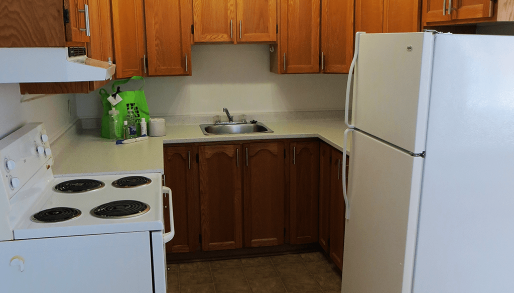 a kitchen with a stove refrigerator and sink