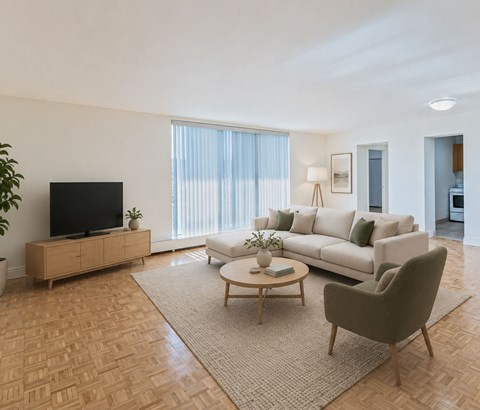 A living room with a sofa, a coffee table, and a television.