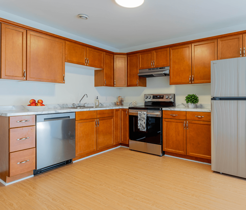A kitchen with wooden cabinets and a white refrigerator.