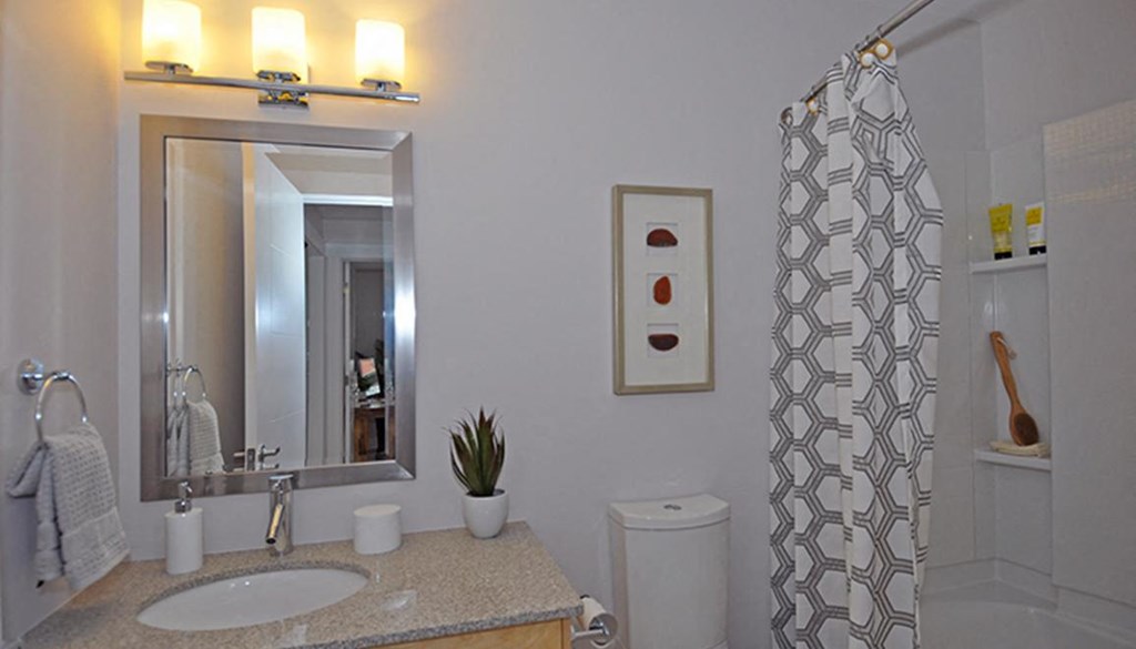 a white bathroom with a sink and a mirror