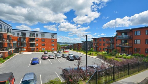 a view of a parking lot in front of some apartment buildings