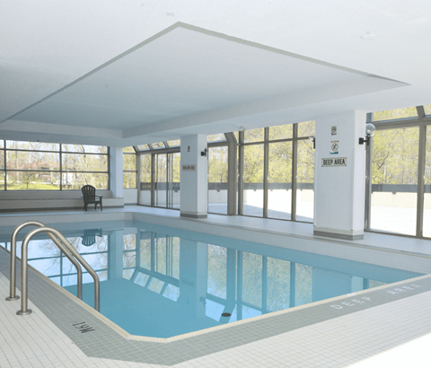 A large indoor swimming pool with a sign that says "JEEP AREA" on the wall.