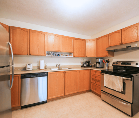 A kitchen with wooden cabinets and stainless steel appliances.