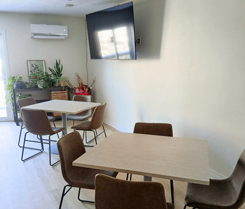 A conference room with a long table and chairs.
