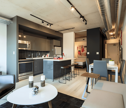 A modern kitchen with a dining table and chairs.