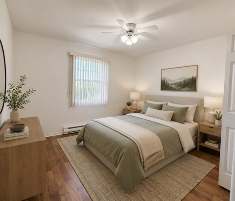 A bedroom with a large bed and a ceiling fan.