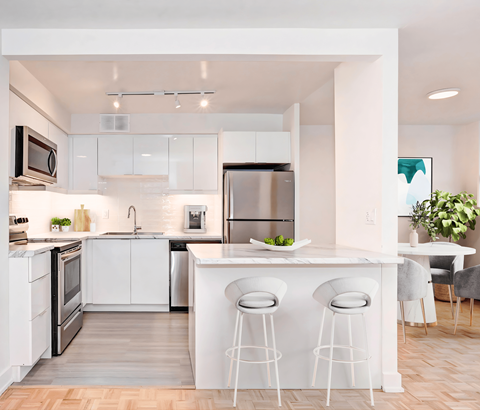 A modern kitchen with white cabinets and a central island.