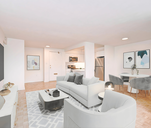 A modern living room with a white sofa and grey chairs.