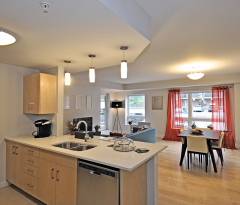A kitchen with wooden cabinets and a white countertop.