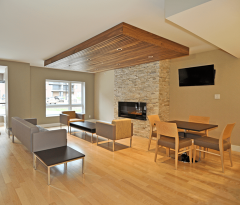 A modern living room with a stone fireplace and a television.