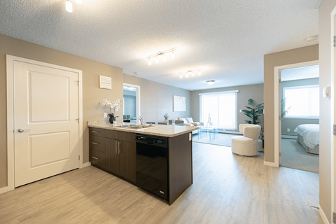 an open kitchen and living room with a bedroom and a pool