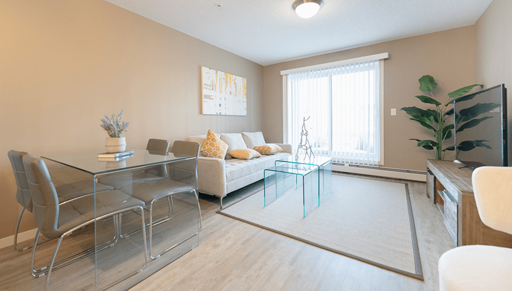 a living room with a glass table and a couch