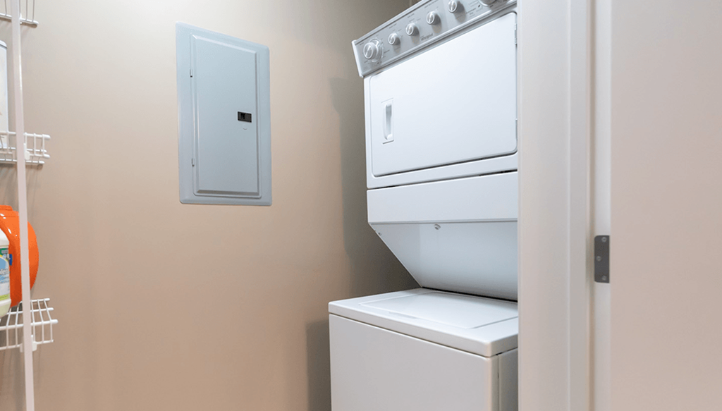 a white washer and dryer in a laundry room with a white door