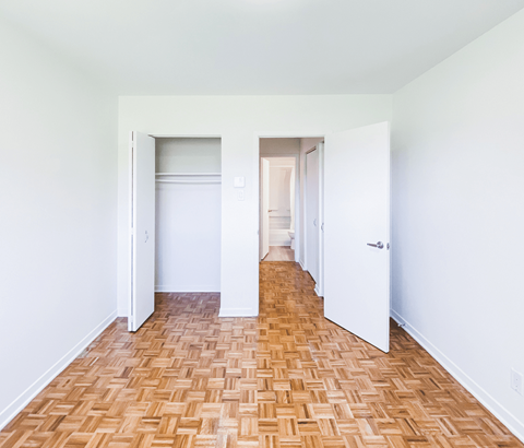 A room with a wooden floor and white walls.