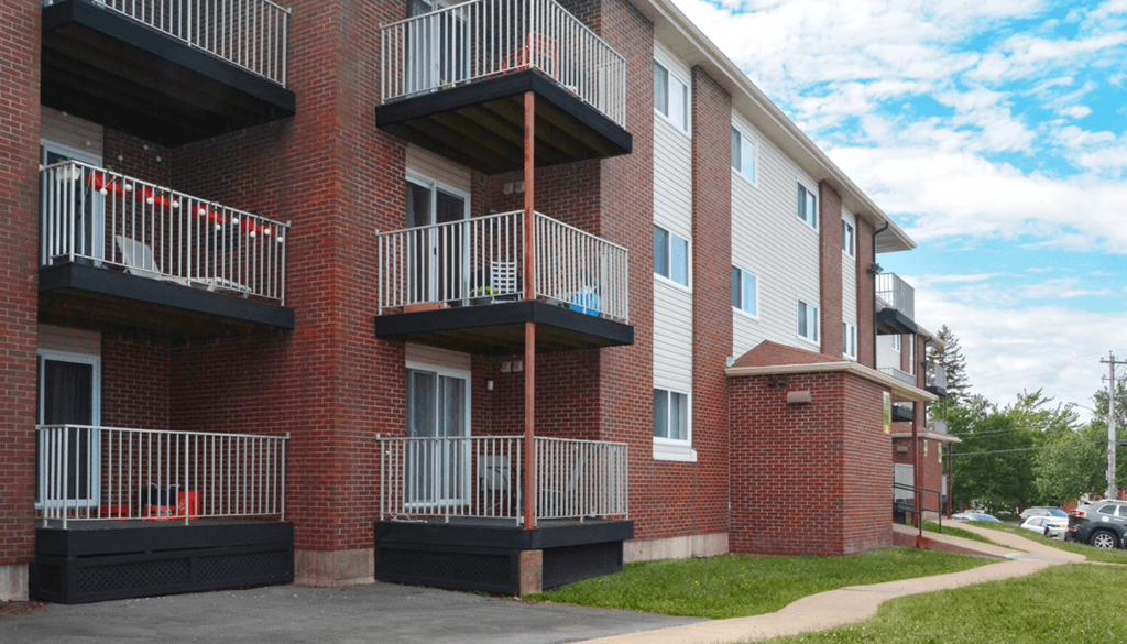 A red brick apartment building with balconies.
