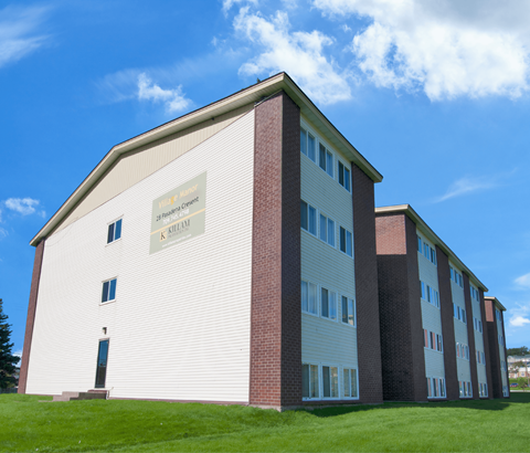 A white and red building with a sign that says "K-12 School".