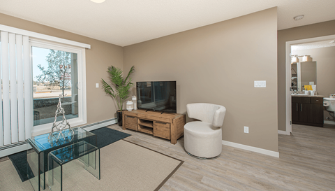 a living room with a tv and a glass table