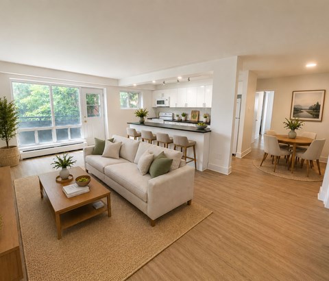 A living room with a white couch and a wooden coffee table.
